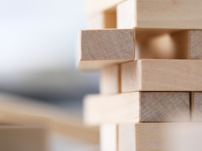 Image of stacked wooden blocks with one pulled out