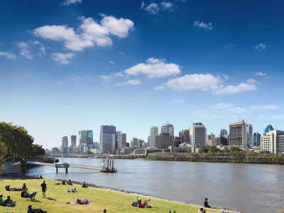 View of people picnicing at South Bank, Brisbane, with Brisbane CBD in the background