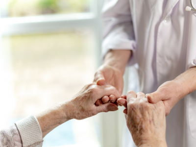 Image of two people standing holding hands