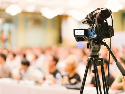 Image of a camera and microphone recording at an event