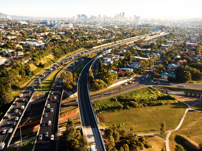 Three major roads shown curving with city in the distance