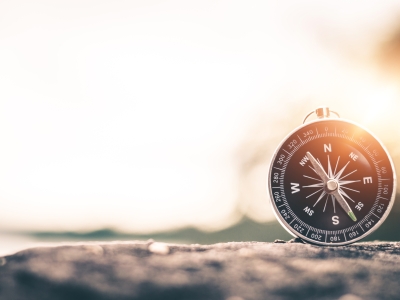 Compass resting on a rock