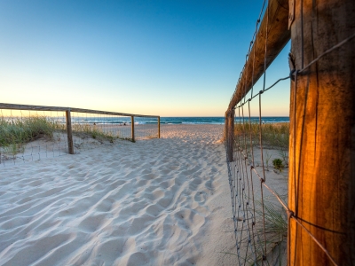 Image of the walkway fence and sand to a Coolangatta beach