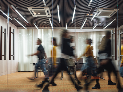 Time lapse image of people walking through an office