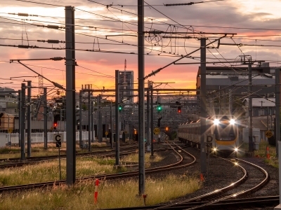 Train entering Roma Street Station Brisbane at sunset