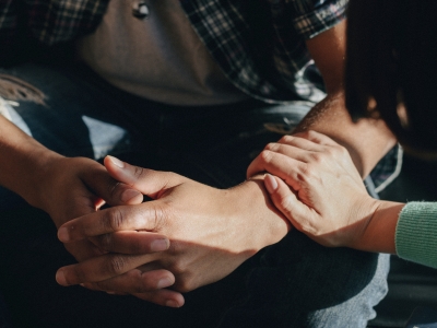 Report image: Woman consoling a man by placing her hand on his arm