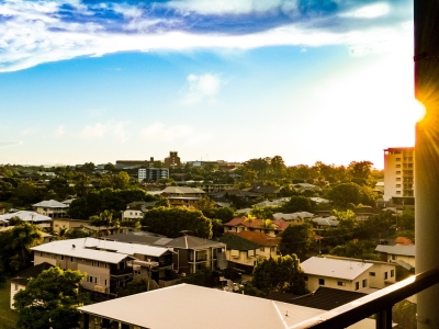 Report thumbnail: view from balcony, looking over houses with sun shining on the right