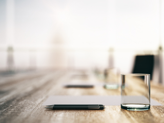 Board room table with pen and water glass