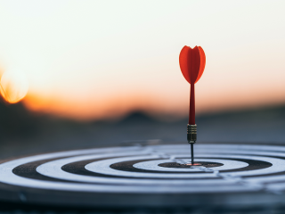 Image of a dart hitting the bullseye on a target