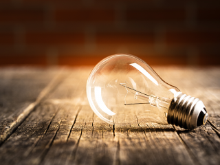 Image of a lightbulb on a wooden table