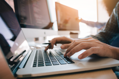 Person typing on a computer keyboard