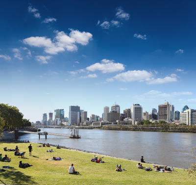 View of people picnicing at South Bank, Brisbane, with Brisbane CBD in the background