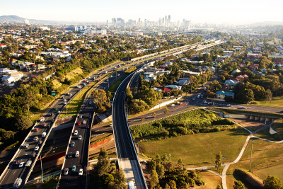 Three major roads shown curving with city in the distance