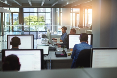 Image of a group of people working on computers in an office