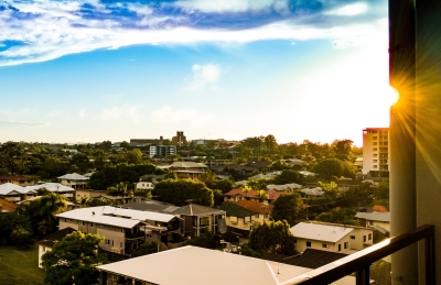 Report thumbnail: view from balcony, looking over houses with sun shining on the right