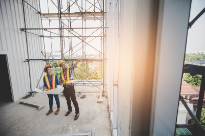 Construction teacher and student on a building site