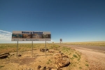 Road sign in outback Queensland displaying 'Welcome to Queensland'